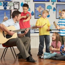 Teacher-male-children-music-singing-happy-sing-to-thrive